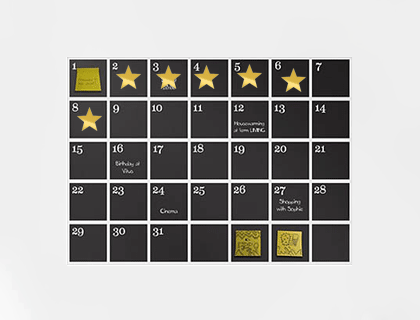 A calendar with gold stars on it, seinfeld-hack style