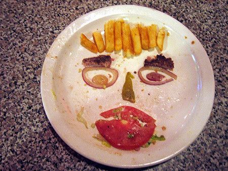 A plate with food left on it, formed into a face