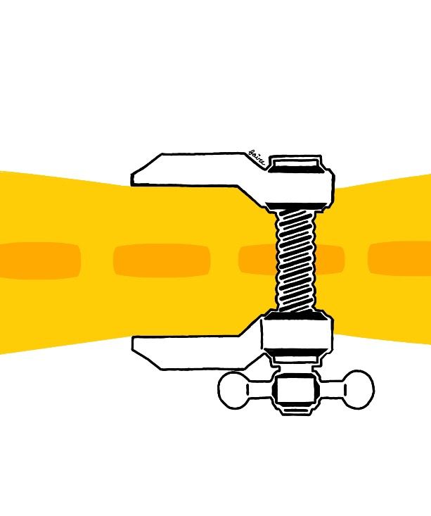 A yellow brick road being squeezed by a vice grip